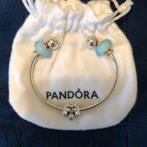 Open “C” bangle bracelet and Lady Disney and glass murano charms from Pandora.